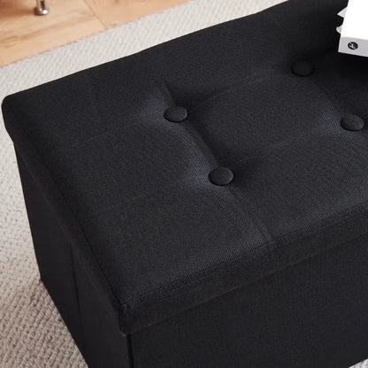 Banc coffre pliable noir avec assise confortable et design décoratif, idéal pour rangement et décoration intérieure.