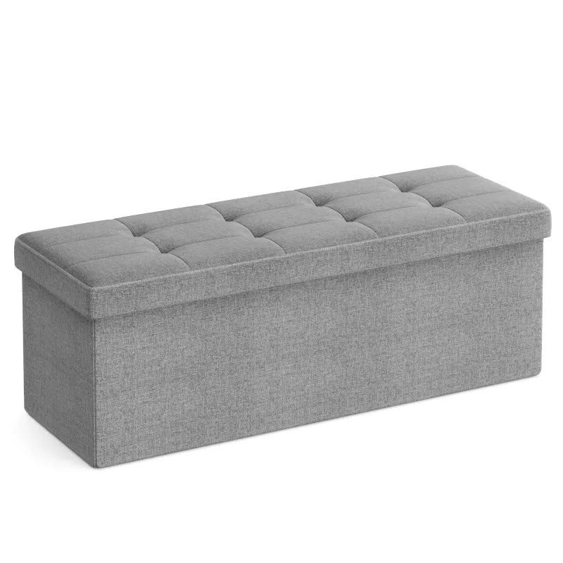Banc coffre scandinave pliable en bois gris clair, design minimaliste et décoratif, idéal pour rangement et décoration intérieure.